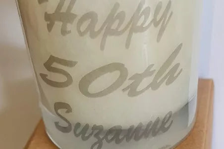 a candle with happy 50th written on it