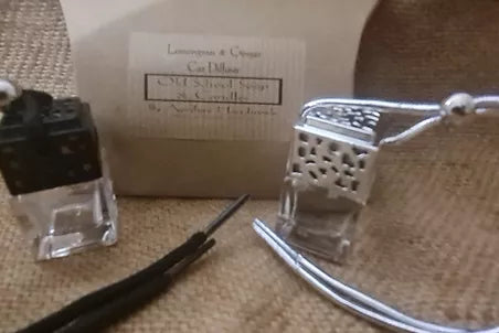 a small silver box with a small silver chain and a small silver chain